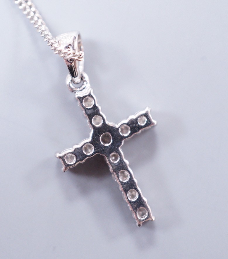 A modern 18ct white gold and diamond cluster set cross pendant, overall 24mm, on an 18ct white gold fine link chain, 48cm, gross weight 3.4 grams